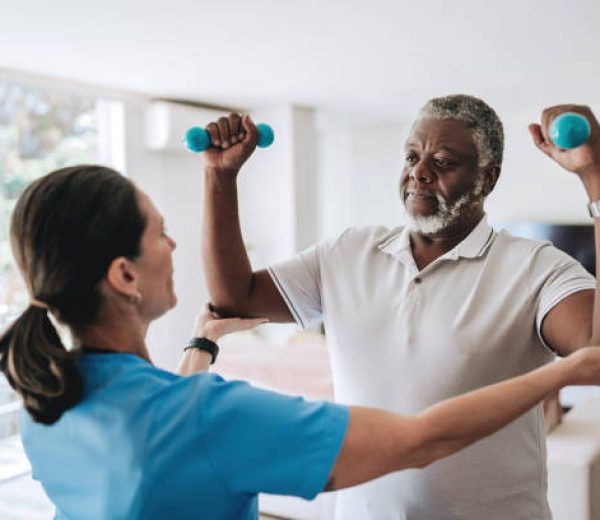 Patient at home doing physiotherapy with dumbbell