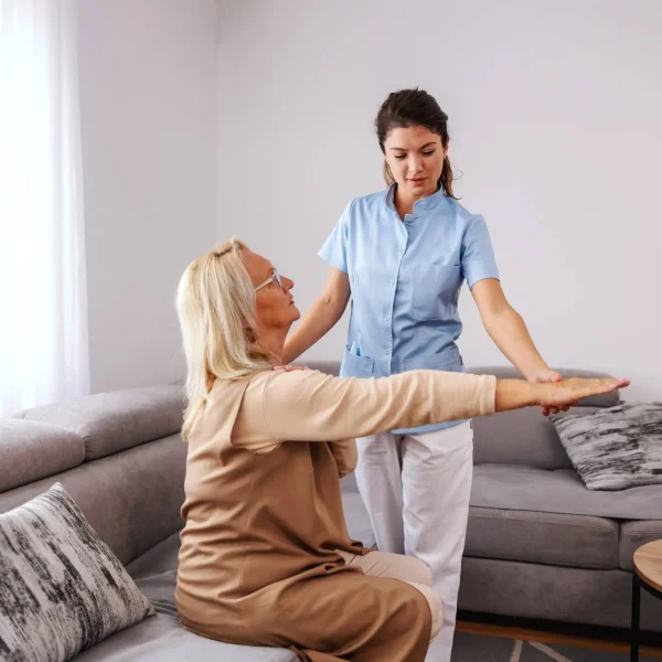 resize_senior-woman-sitting-couch-with-stretched-arm-while-nurse-checking-her-arm